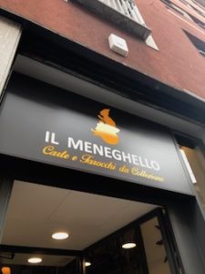 Sign over door to entrance of Il Meneghello shop in Milan, Italy.
