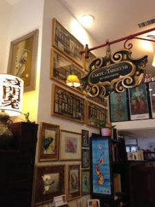 Interior of Il Meneghello shop, showing art-covered walls.