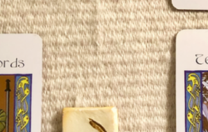 A teaser shot showing just the corners of two of the cards and one part of a rune from this week’s reading.