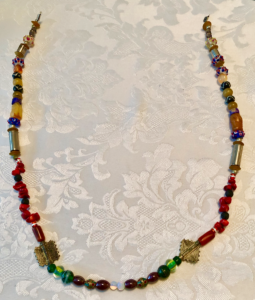 A strand of beads of many colors and sizes.