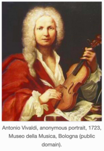 An oil painting of Antonio Vivaldi in a red robe, loosely fitted, open to show the pleated collar, v-neck, and ruffled cuffs of his white shirt. He wears a curly, long white wig. He is holding a quill pen in his right hand, and a violin in his left hand. There are pieces of paper with music written on them, and a pot of ink on the desk in front of him. The caption reads, "Antonio Vivaldi, Anonymous portrait, 1723, Museo della Musica, Bologna (public domain).
