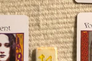 [Image description: A teaser screenshot of this week’s Insight from the Oracles, with just a hint of the cards and runes showing.]