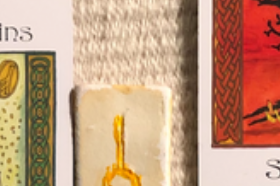 A teaser screenshot of the Monthly Overview spread, with just a hint of the cards and runes showing.