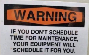 A photo of a sign reading, "Warning: If you don't schedule time for maintenance, your equipment will schedule it for you."
