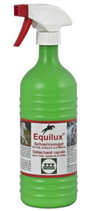 A green bottle with a white spray nozzle and red tip. The label shows a silhouette of person riding a horse which is jumping, and the Equilux brand information.