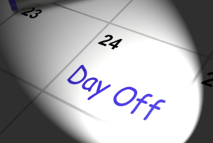 A close-up of a calendar page with the words Day Off written it.