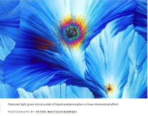 A variegated blue backgrruond with two spots of mixed colors, looking rather like peacock feathers.