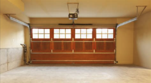 A photo of an empty garage, with the moving door closed.