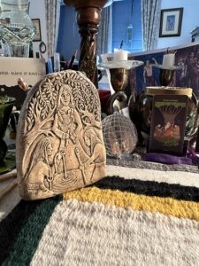 A small plaster tablet showing the three Norns.